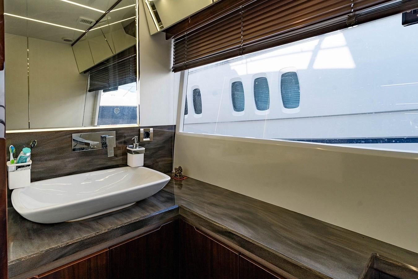 a bathroom with a sink and a large window aboard AQUAMARINA Yacht for Sale