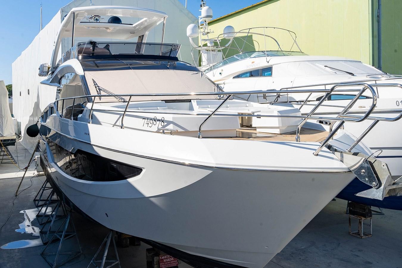 a white boat on a dock aboard AQUAMARINA Yacht for Sale