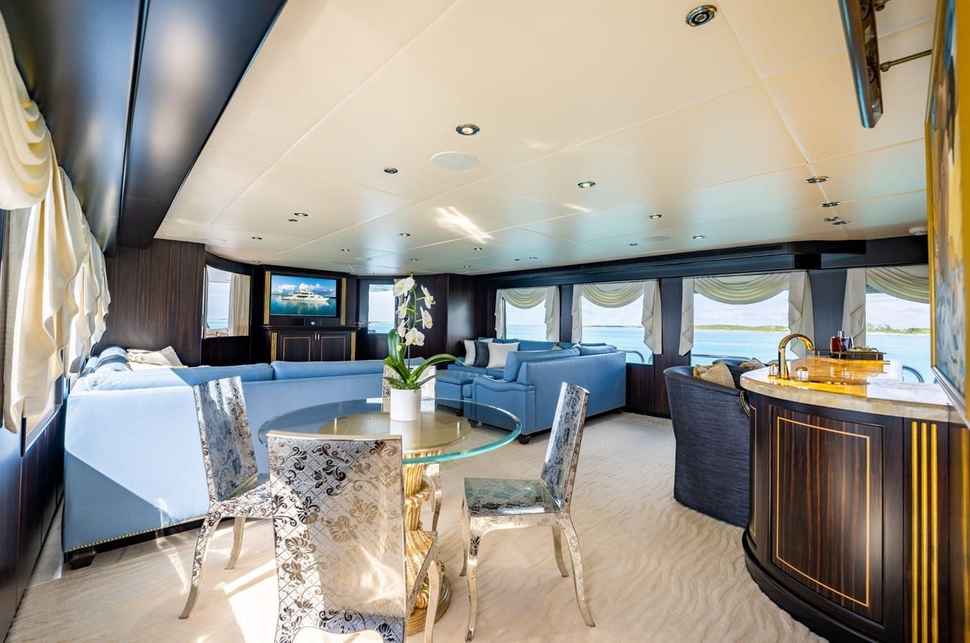 a large living room with a large table and chairs aboard GRADE I Yacht for Charter