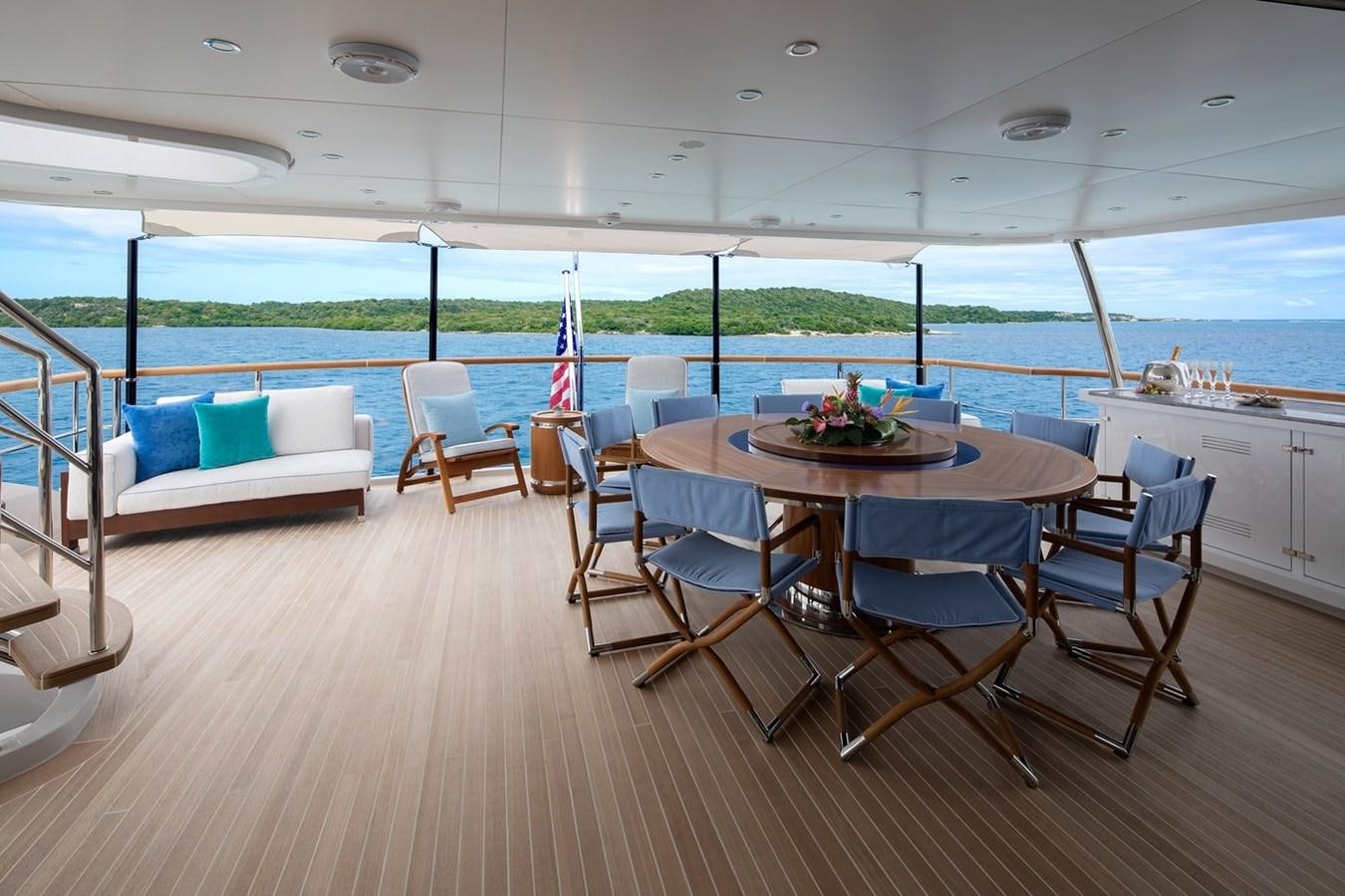 a large dining table on a deck aboard JODI ANN Yacht for Charter