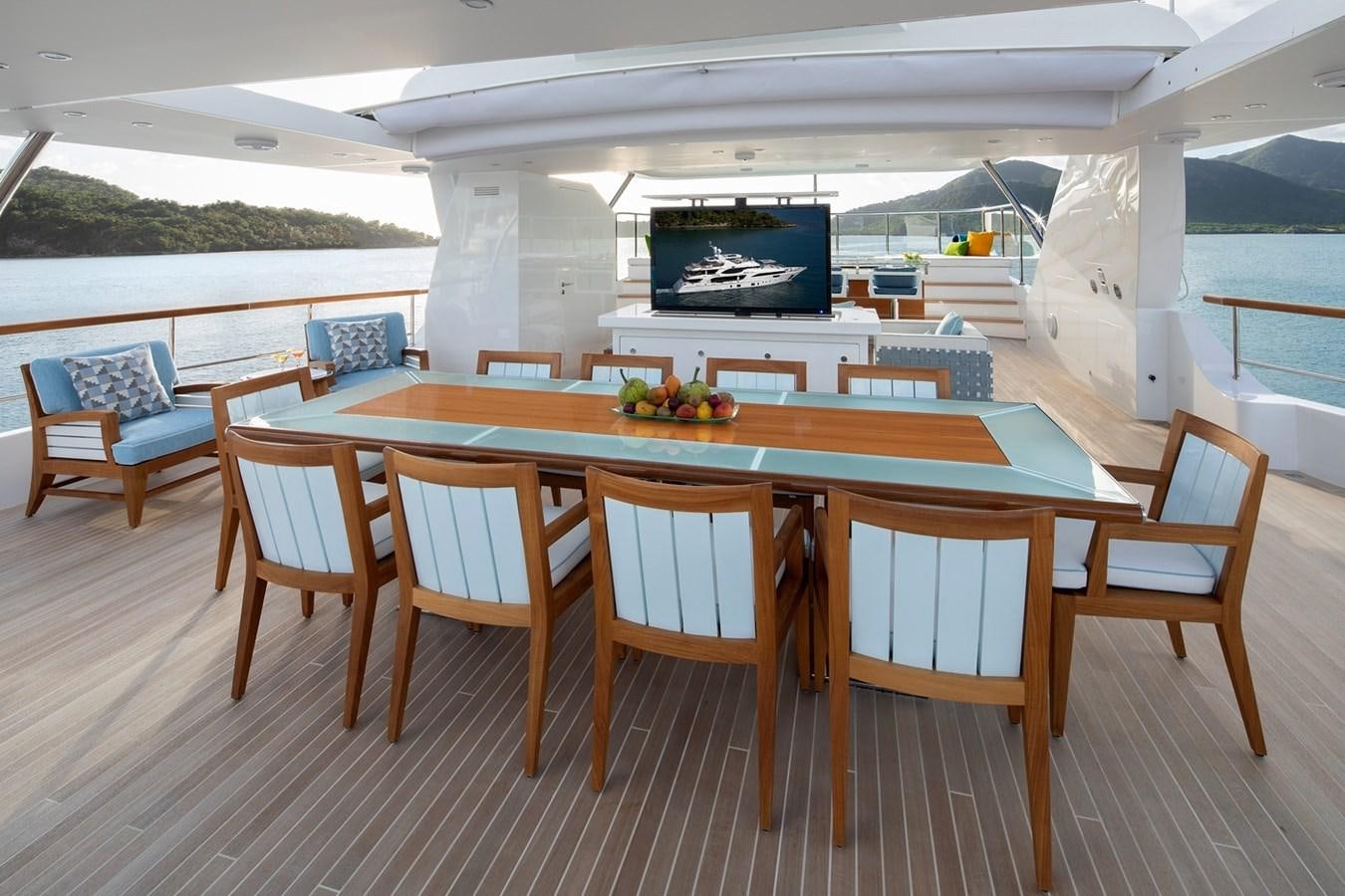 a table with chairs around it aboard JODI ANN Yacht for Charter