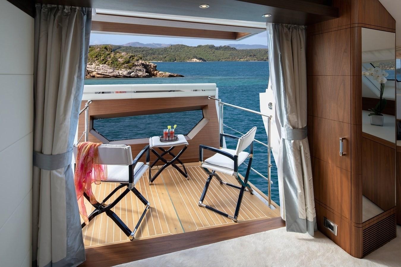 a balcony with a table and chairs aboard JODI ANN Yacht for Charter