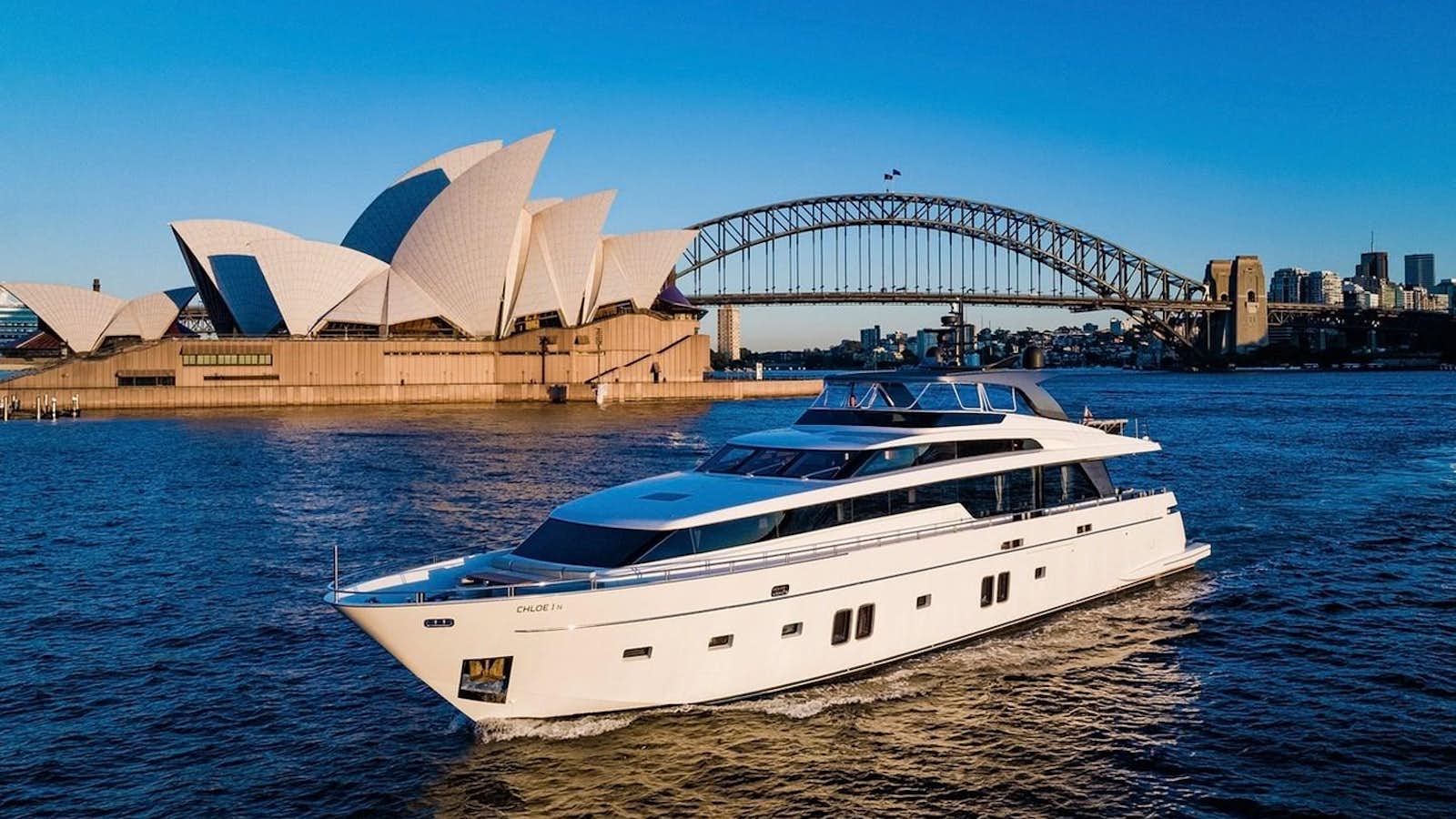 a boat on the water with Sydney Opera House in the background aboard CHLOE I Yacht for Sale