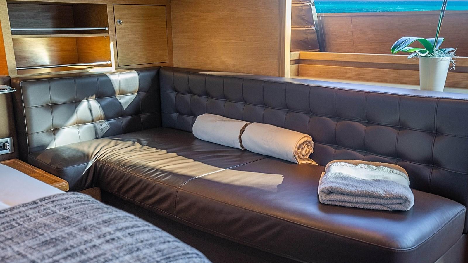 a bed with pillows aboard PATRON Yacht for Sale