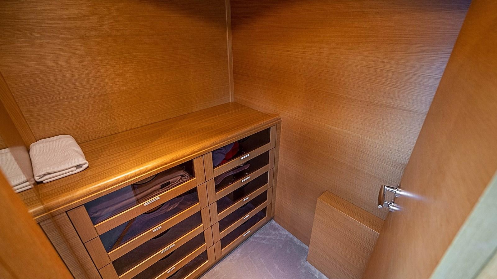 a wooden cabinet with drawers aboard PATRON Yacht for Sale
