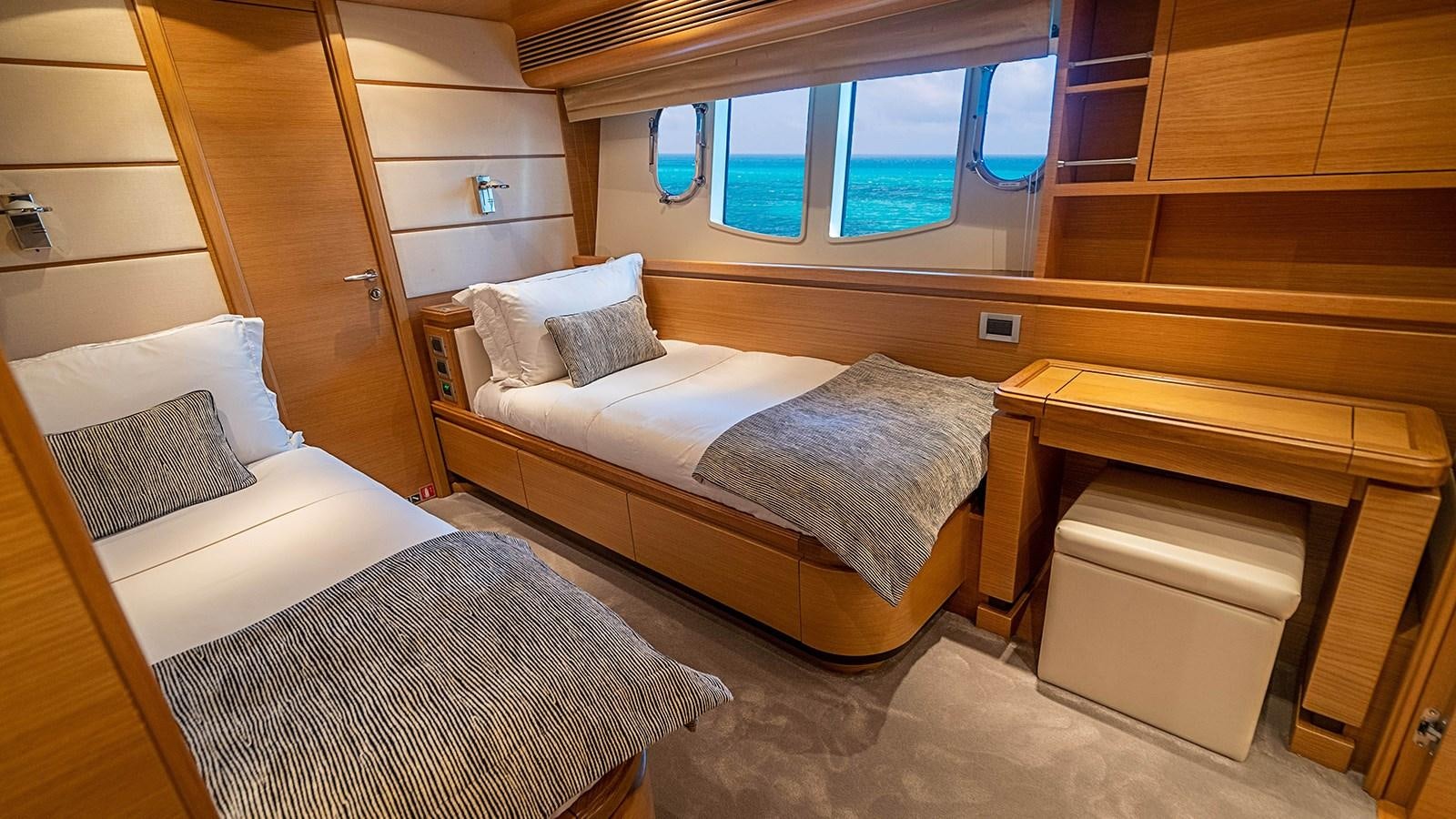 a room with a bed and a desk aboard PATRON Yacht for Sale