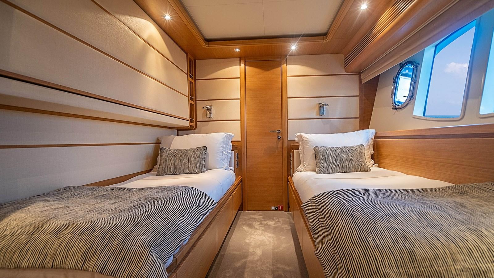 a room with two beds aboard PATRON Yacht for Sale