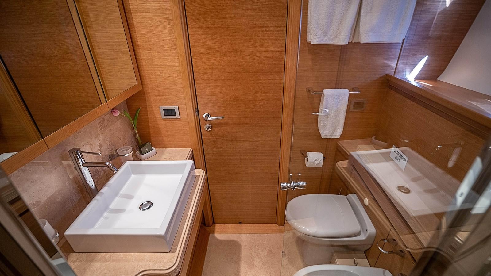 a bathroom with a sink toilet and a bathtub aboard PATRON Yacht for Sale