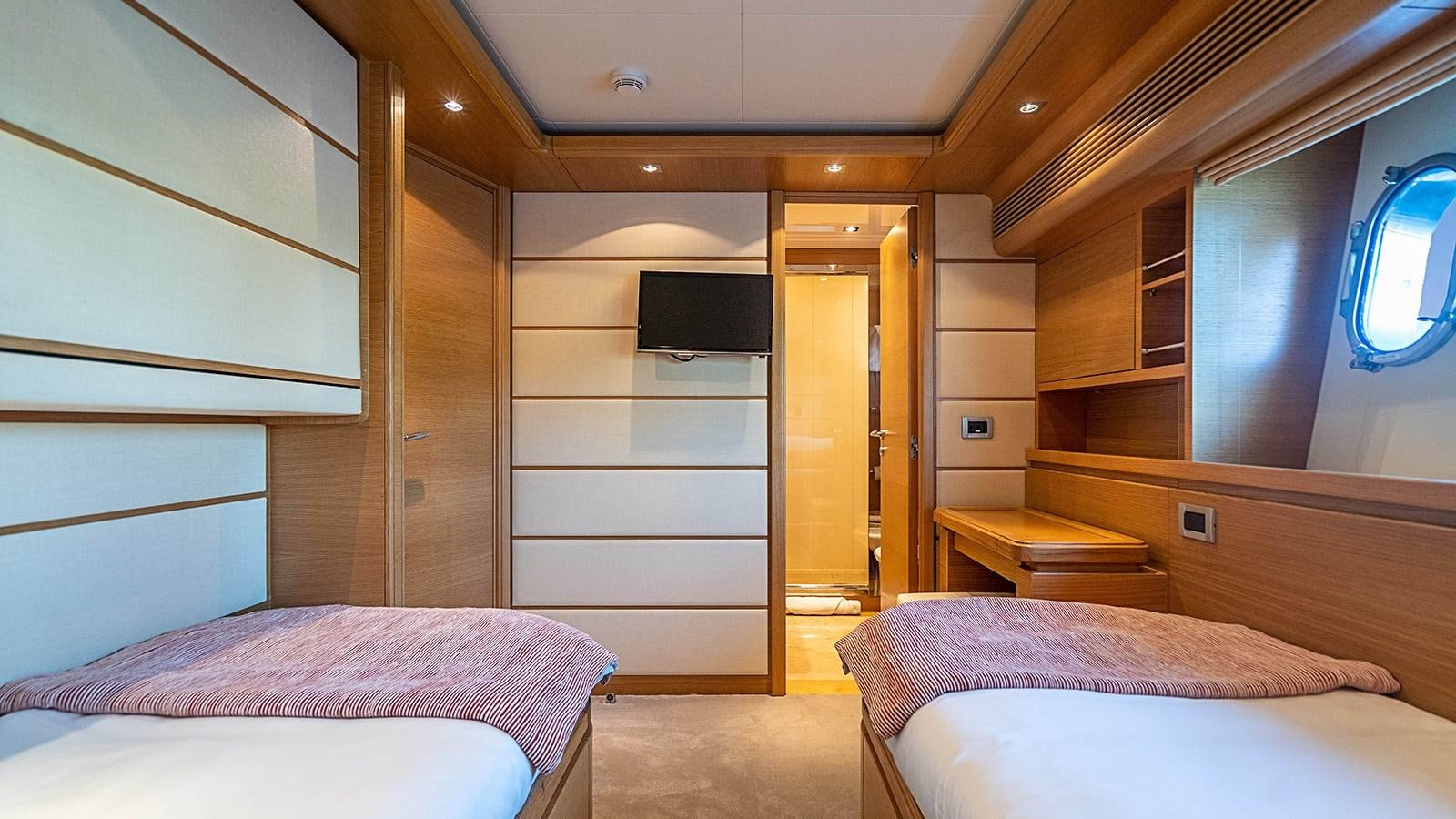 a room with two beds aboard PATRON Yacht for Sale