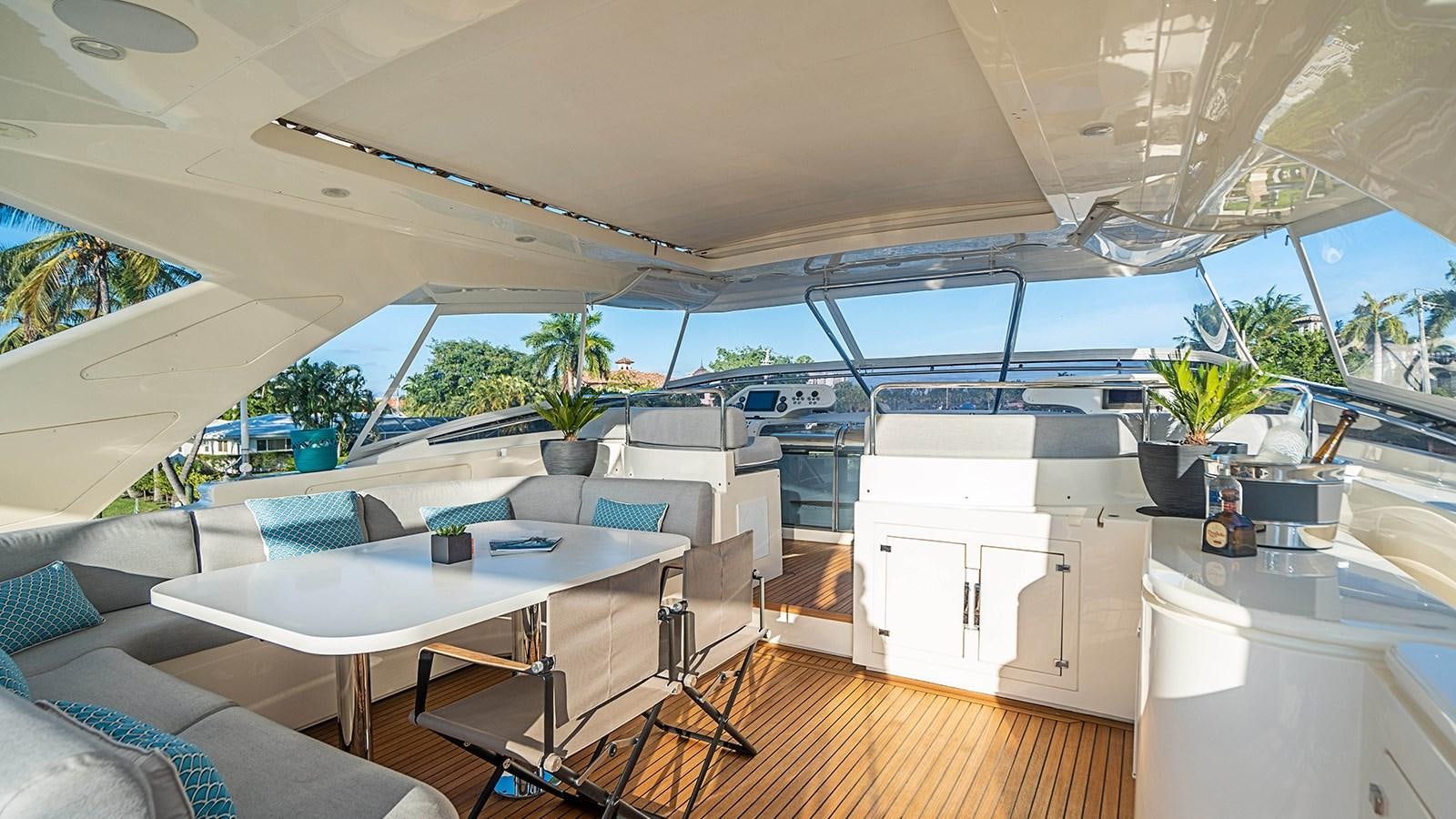a room with a table and chairs aboard PATRON Yacht for Sale