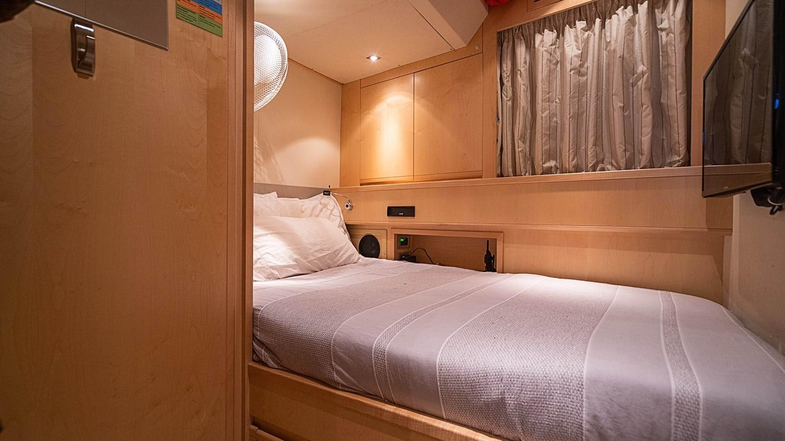 a bed with a white sheet aboard PATRON Yacht for Sale