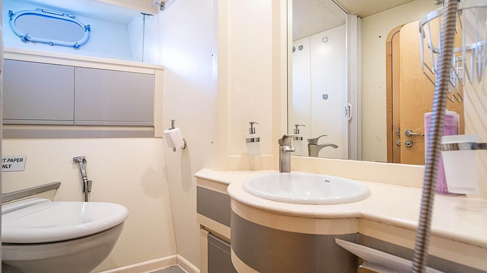 a bathroom with a sink and a mirror aboard PATRON Yacht for Sale