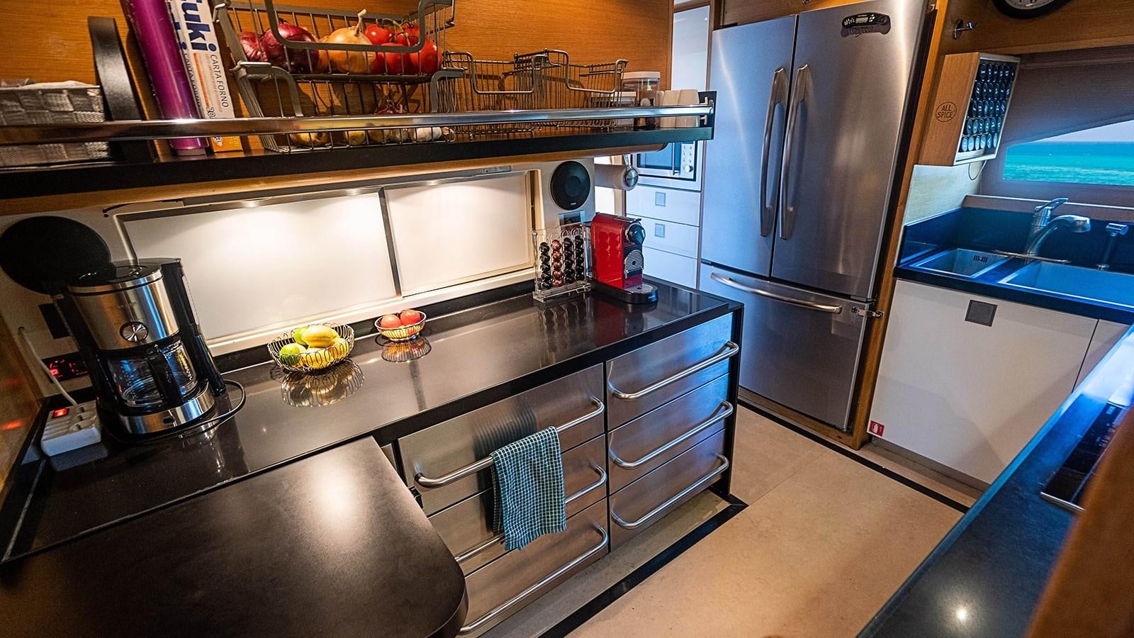 a kitchen with a stainless steel counter aboard PATRON Yacht for Sale