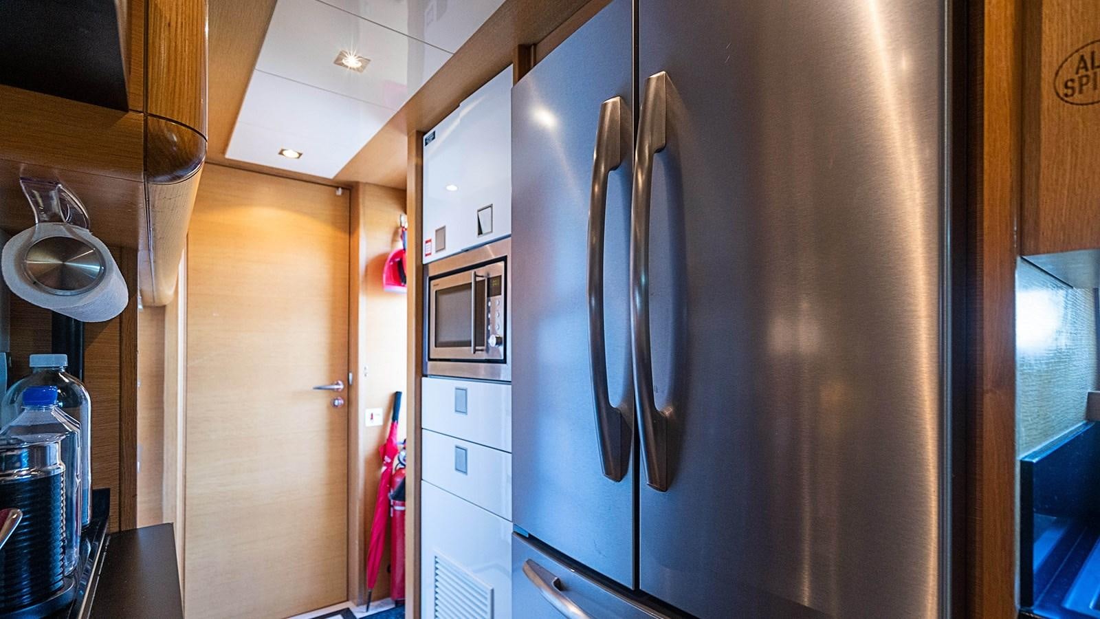 a kitchen with a fridge aboard PATRON Yacht for Sale