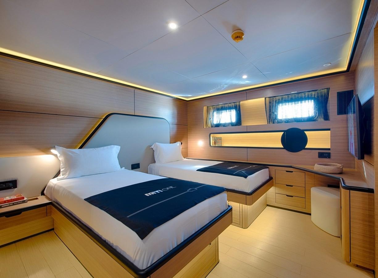 a room with a bed and a desk aboard MITI ONE Yacht for Charter