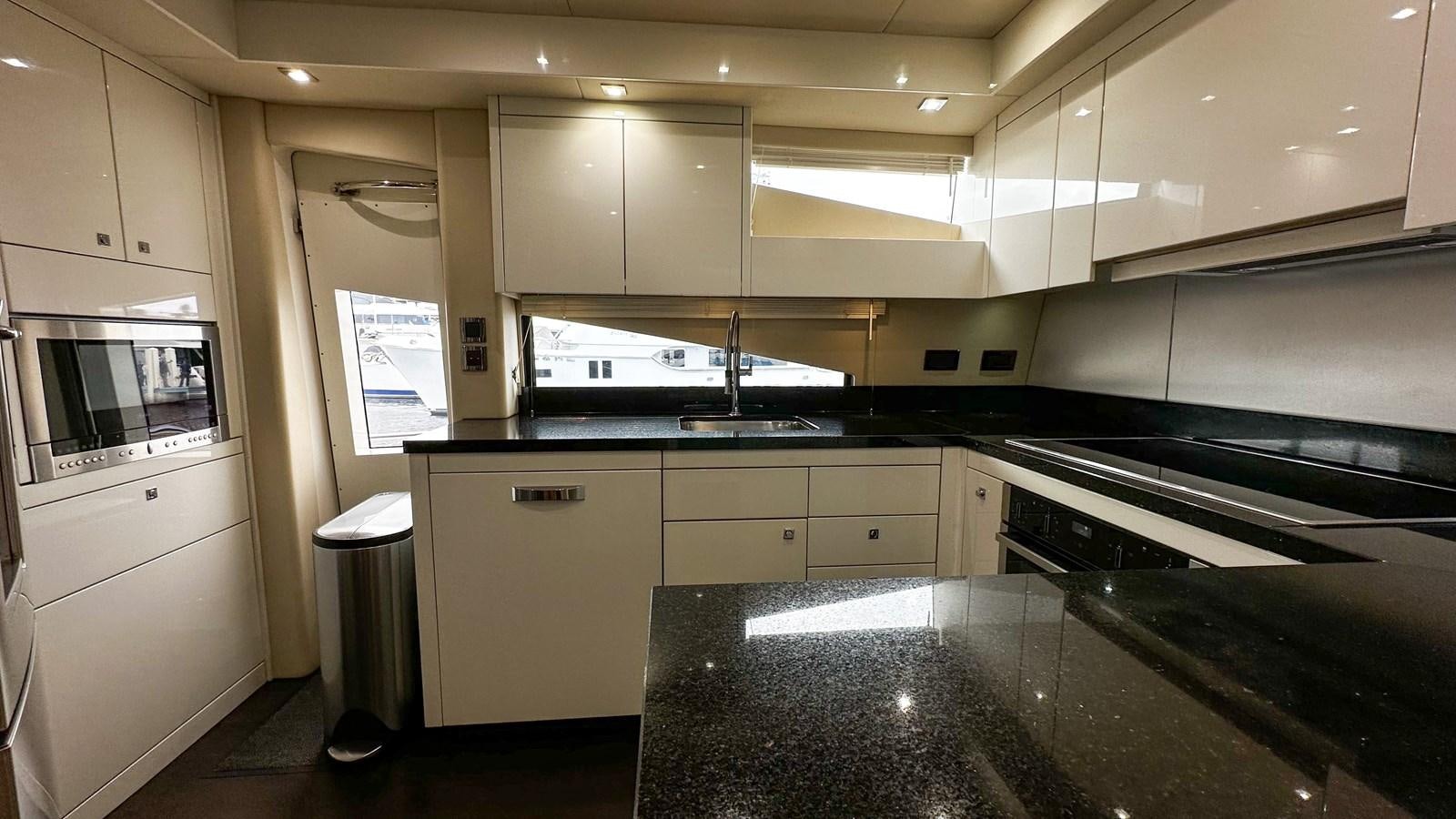 a kitchen with a black counter aboard SOFI V Yacht for Sale