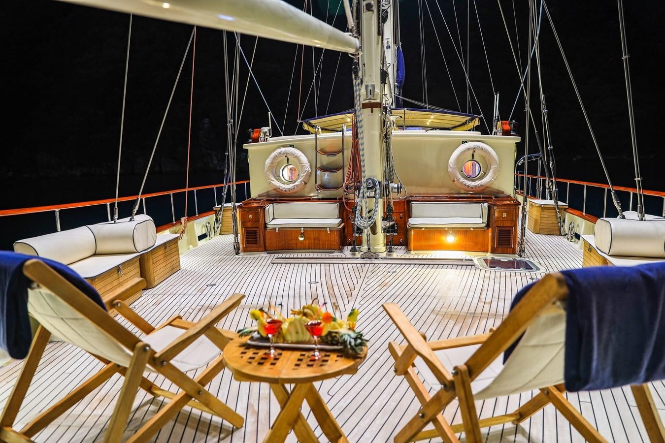 a table with a chair and a sewing machine on it aboard OFELIA Yacht for Sale