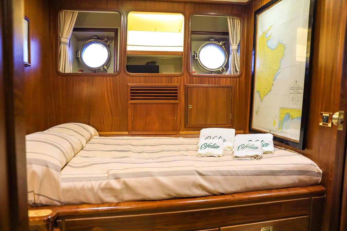 a bed with a mirror above it aboard OFELIA Yacht for Sale