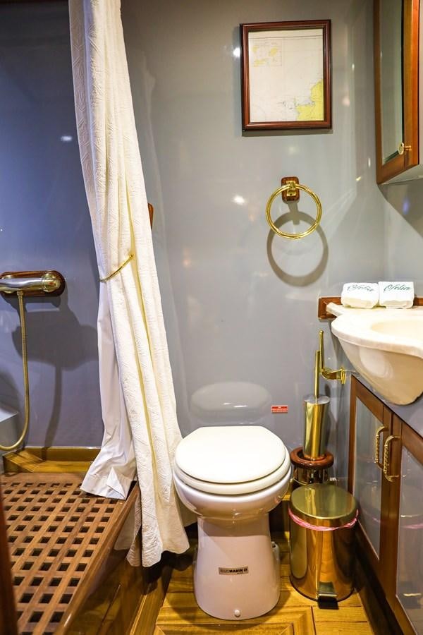 a bathroom with a toilet and sink aboard OFELIA Yacht for Sale