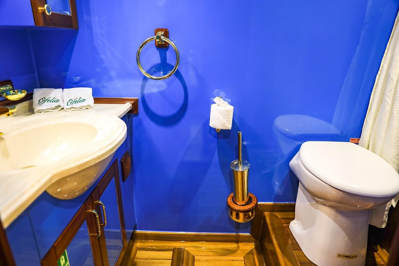 a bathroom with a toilet sink and a mirror aboard OFELIA Yacht for Sale