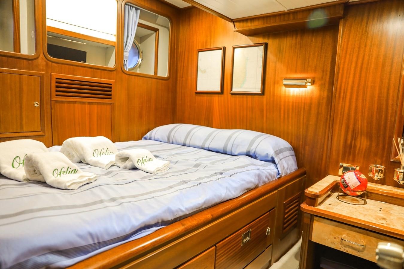 a bed with white sheets aboard OFELIA Yacht for Sale