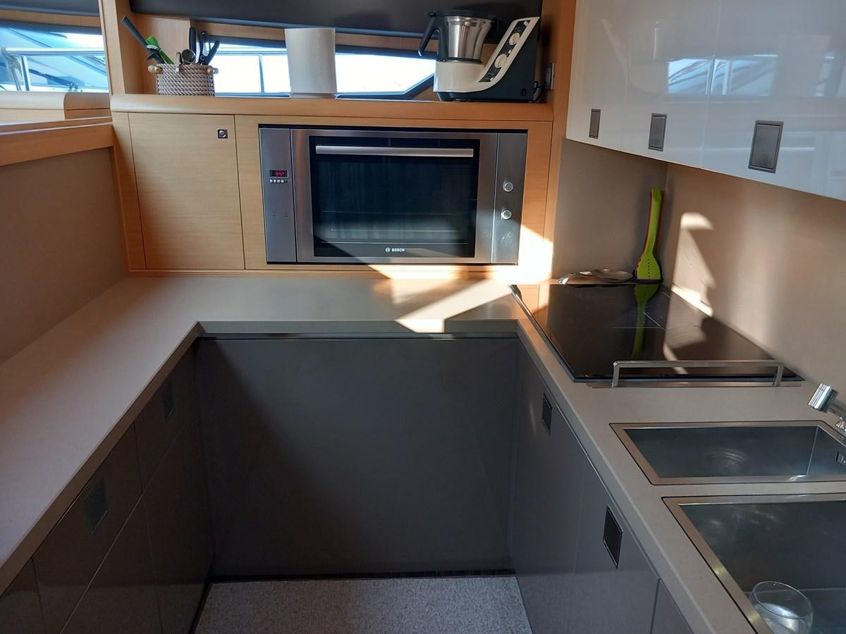 a kitchen with a microwave oven and a sink aboard ALIN Yacht for Sale