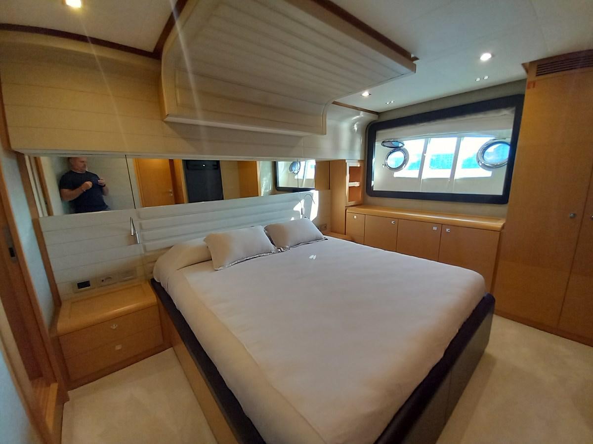a room with a bed and a mirror aboard ALIN Yacht for Sale