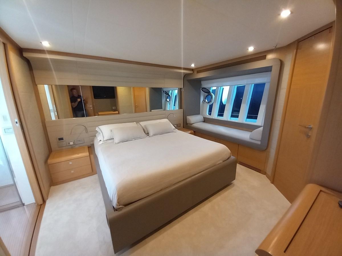 a bedroom with a bed and a window aboard ALIN Yacht for Sale