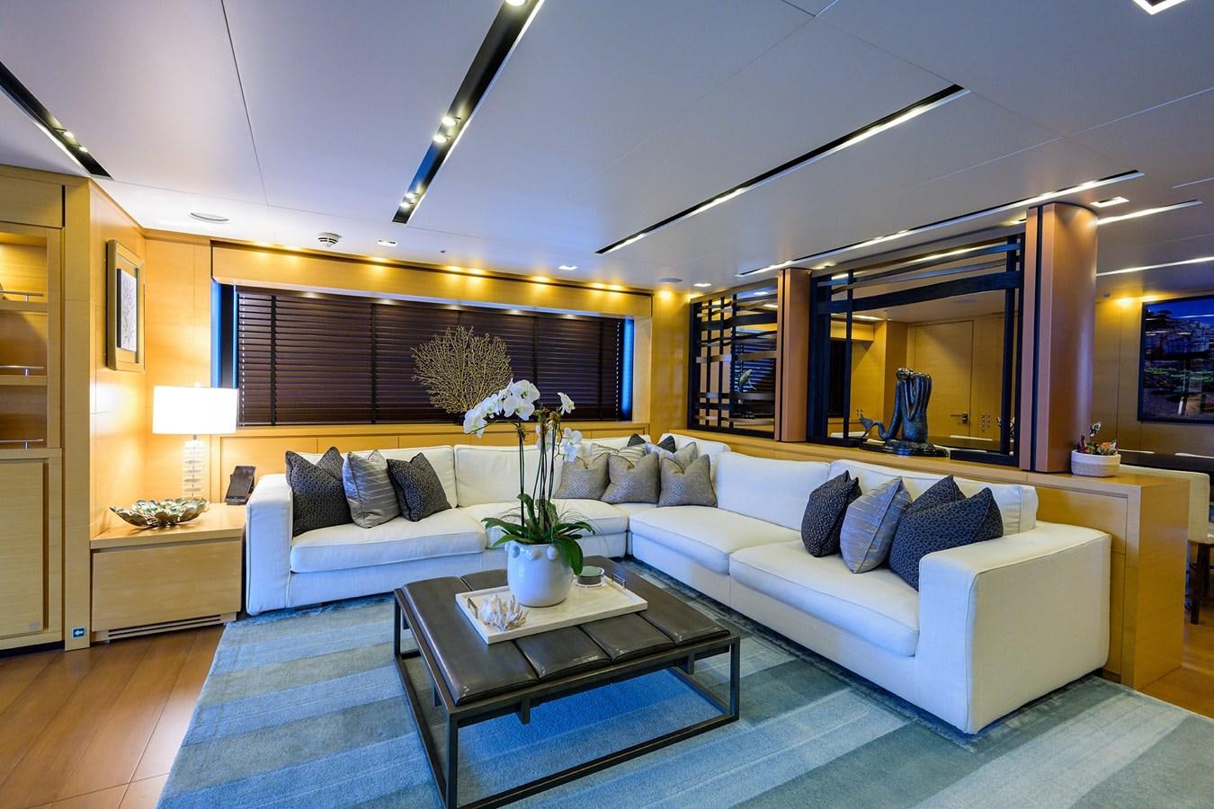 a living room with a large sofa aboard AWAY Yacht for Charter