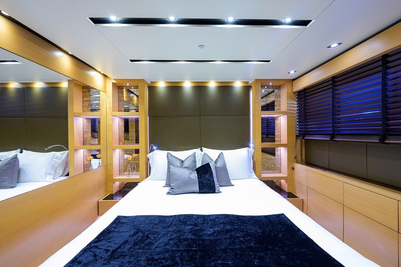 a room with a bed and a bookcase aboard AWAY Yacht for Charter