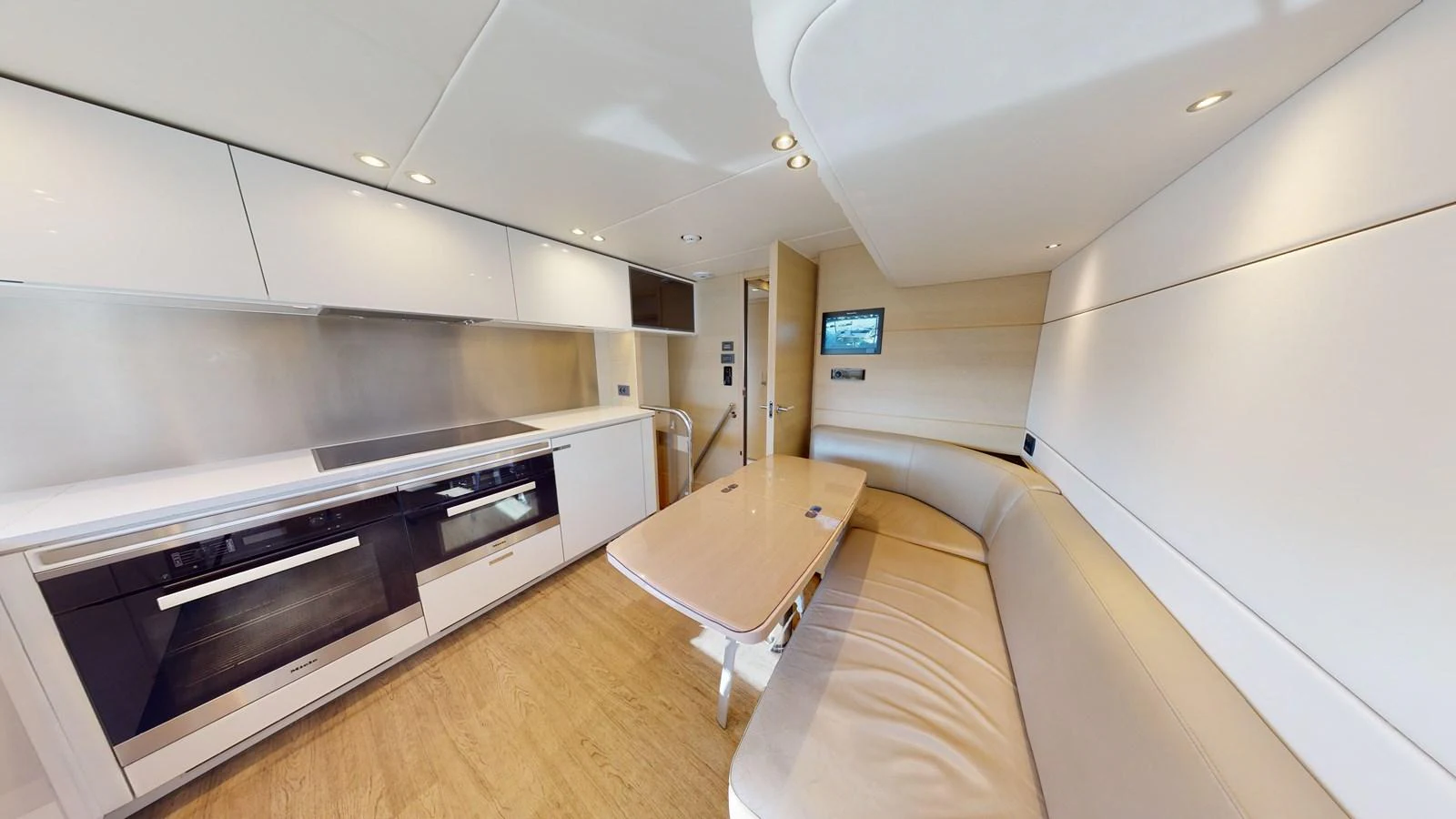 a kitchen with a table and a couch aboard HALLELUJAH Yacht for Charter