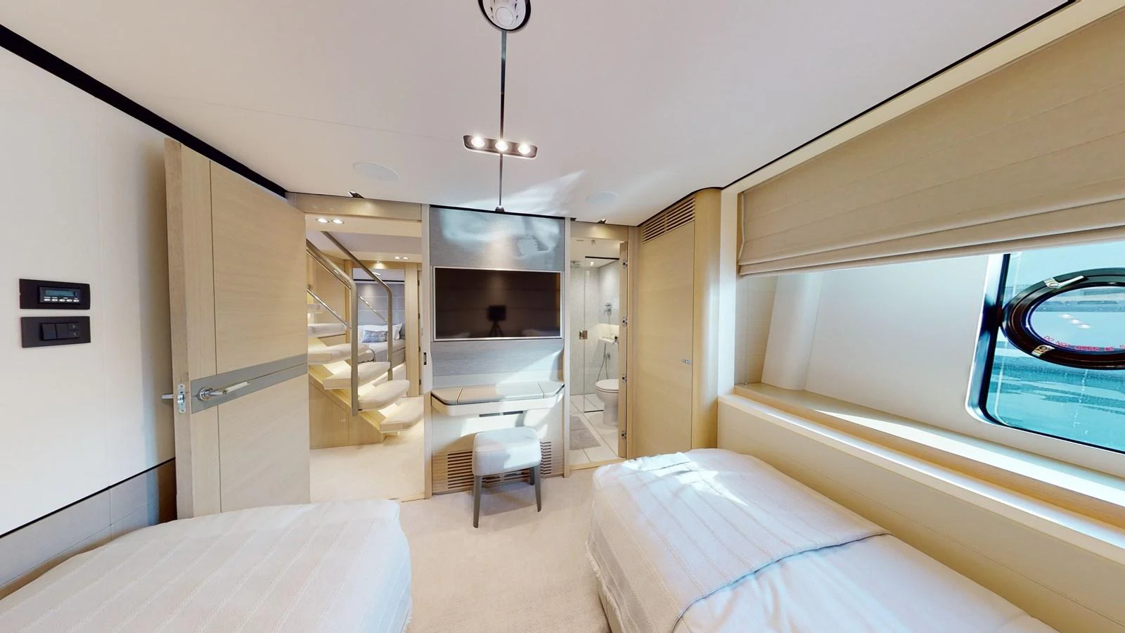a room with a bed and a table and a staircase aboard HALLELUJAH Yacht for Charter