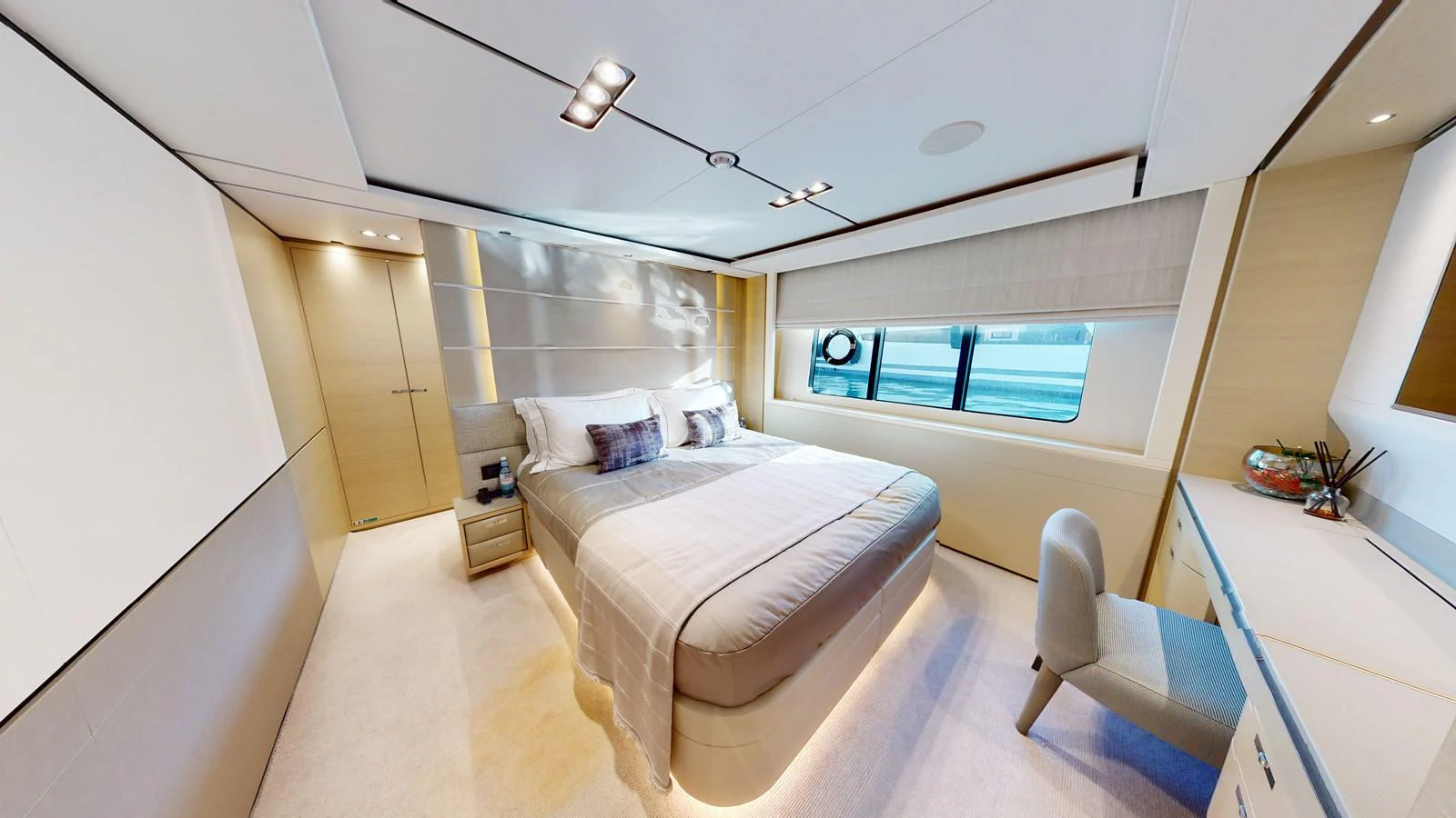 a bedroom with a bed and a desk aboard HALLELUJAH Yacht for Charter