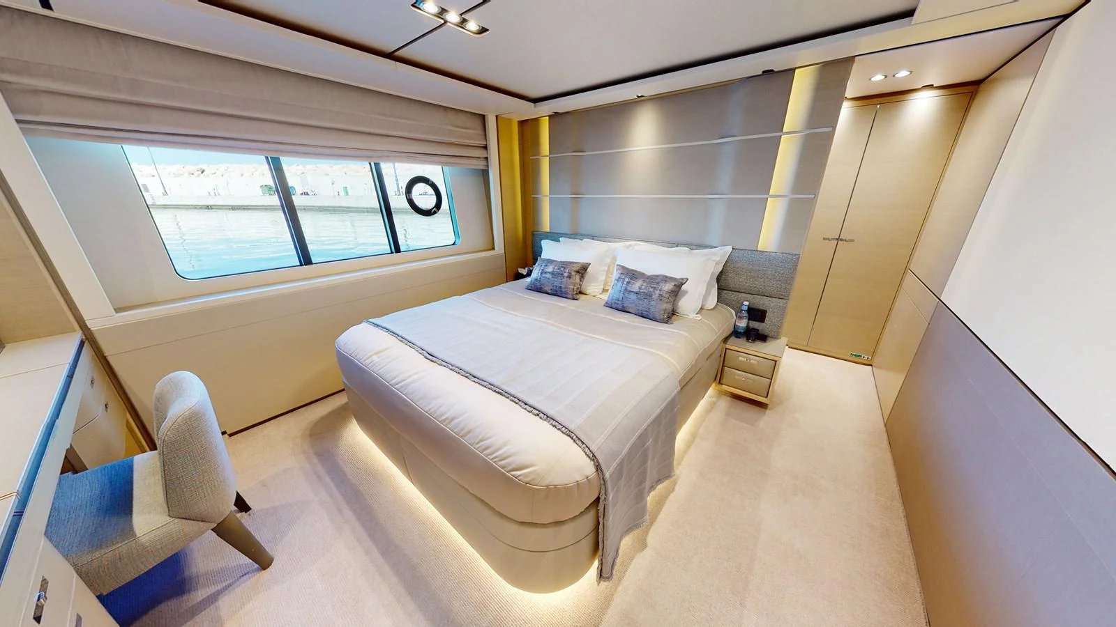 a bedroom with a bed and a chair aboard HALLELUJAH Yacht for Charter