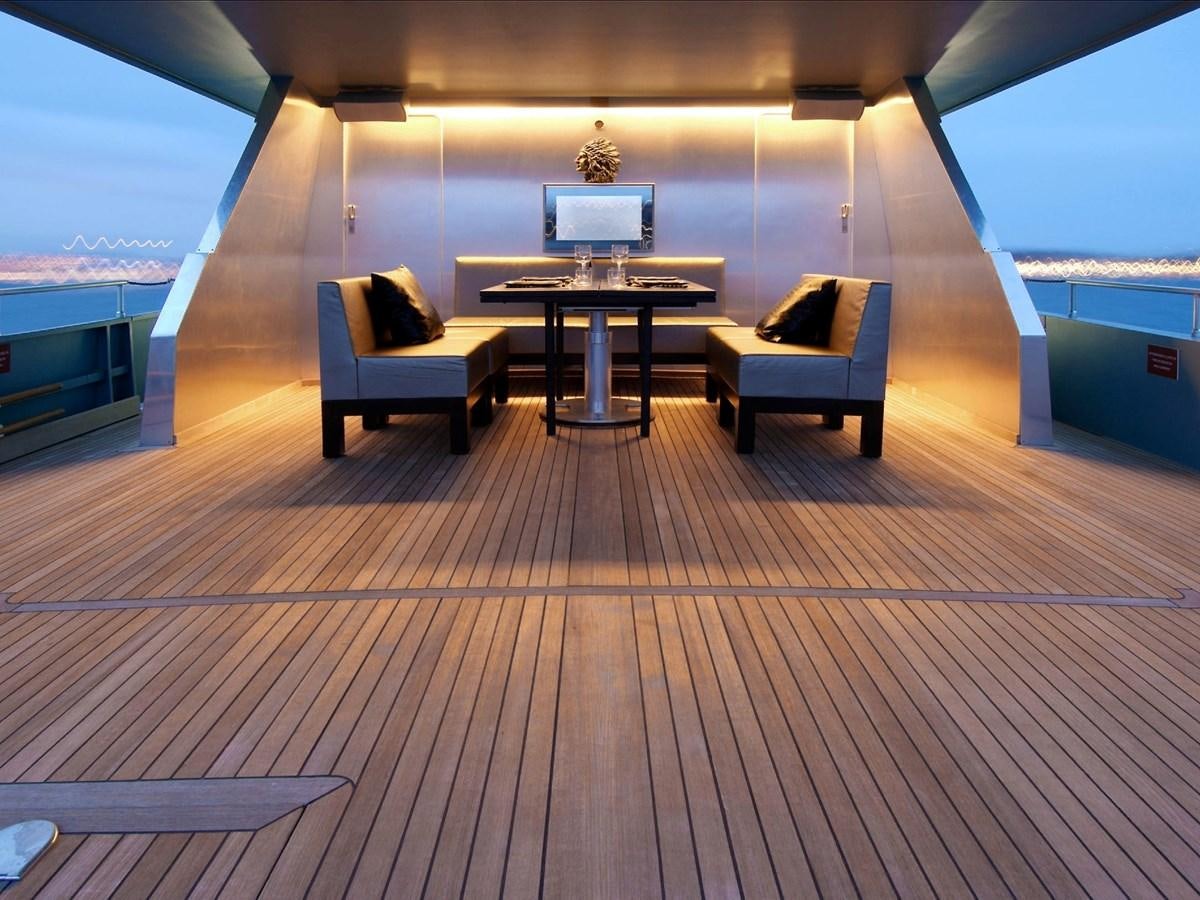 a room with a table and chairs aboard CHATO Yacht for Sale
