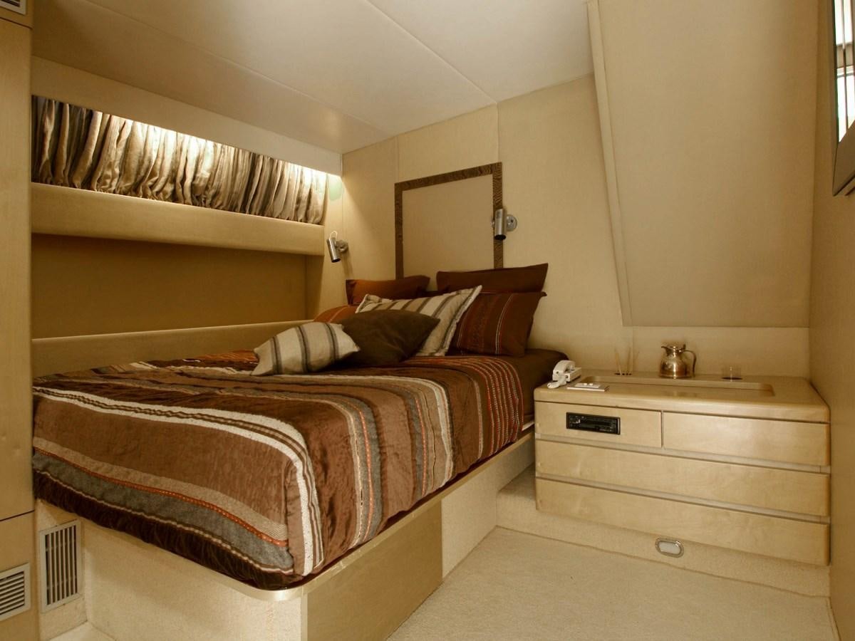 a bedroom with a bed and a sink aboard CHATO Yacht for Sale
