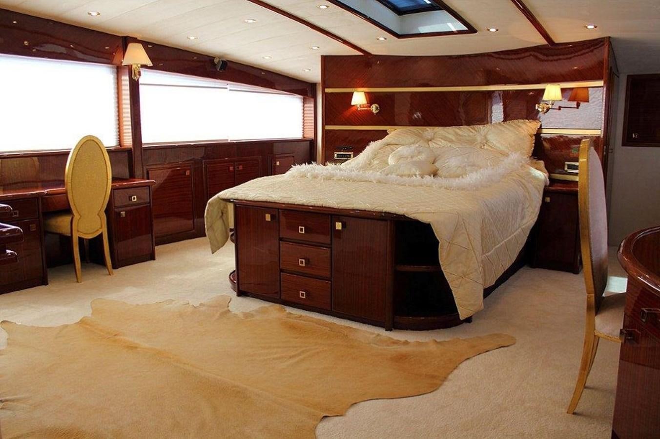 a bedroom with a bed and a desk aboard DENIZ Yacht for Sale