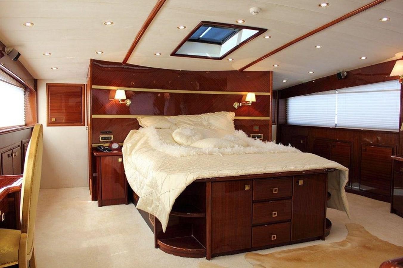 a bedroom with a bed and a desk aboard DENIZ Yacht for Sale