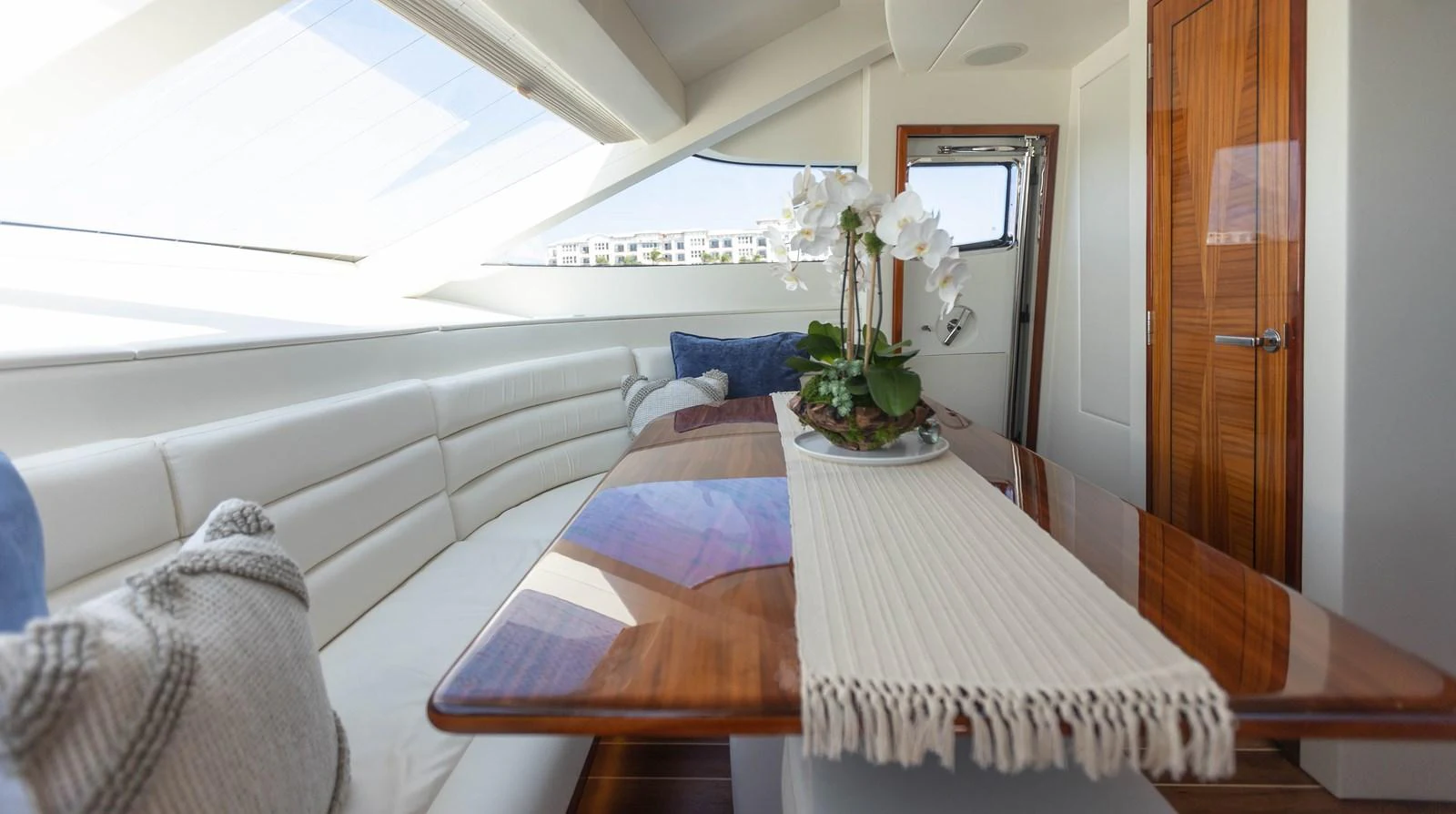 a room with a table and couch aboard CA'D'ZAN Yacht for Sale