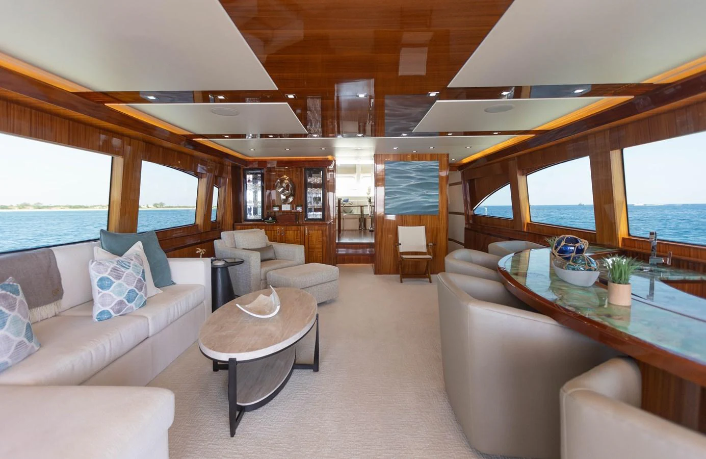 a living room with a table and couches aboard CA'D'ZAN Yacht for Sale