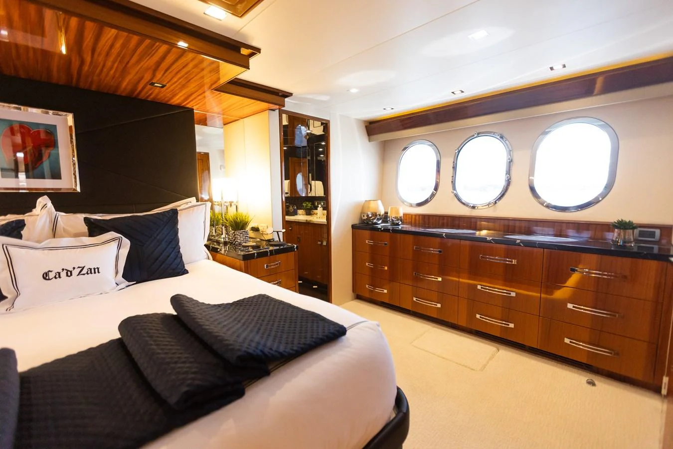 a room with a bed and a dresser aboard CA'D'ZAN Yacht for Sale
