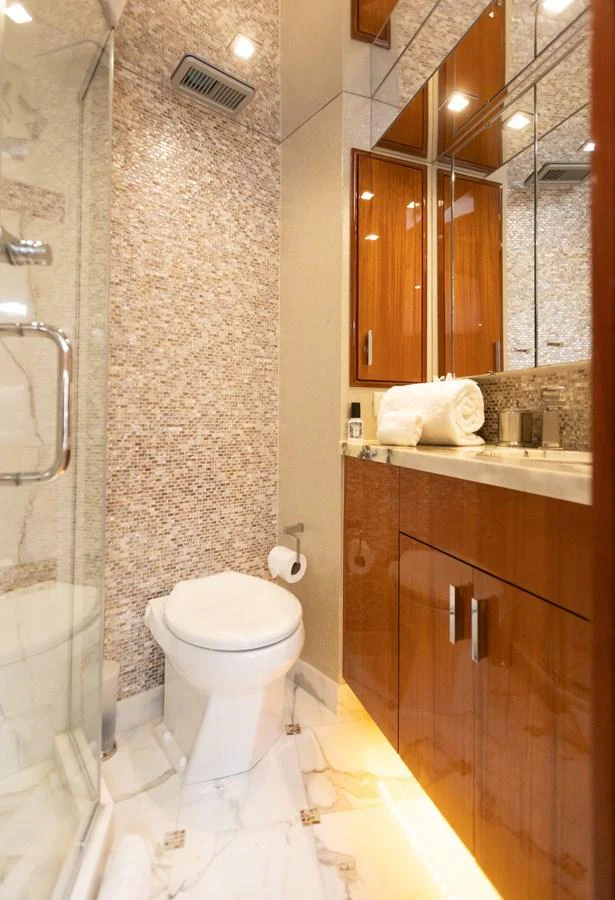 a bathroom with a toilet and a mirror aboard CA'D'ZAN Yacht for Sale