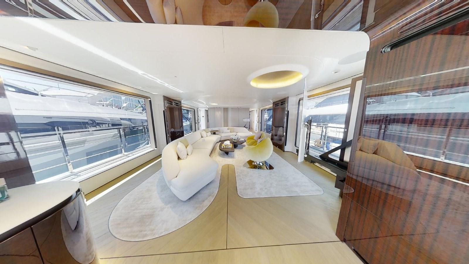 inside of a building with a large window and a table with chairs aboard VOLO MARE Yacht for Sale