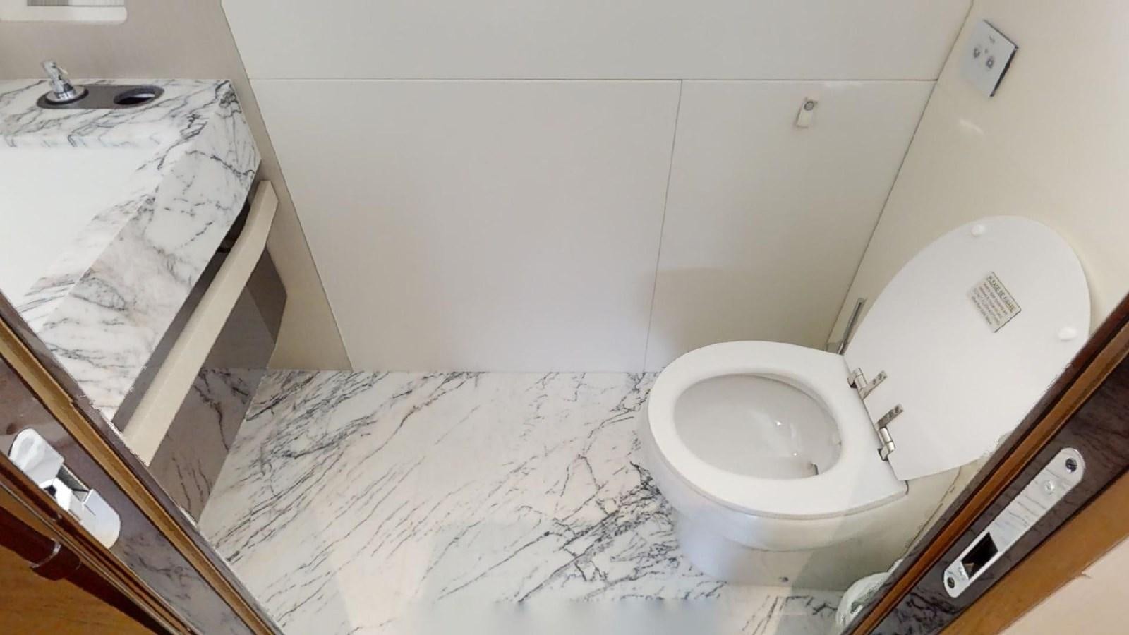 a bathroom with a toilet and a sink aboard VOLO MARE Yacht for Sale