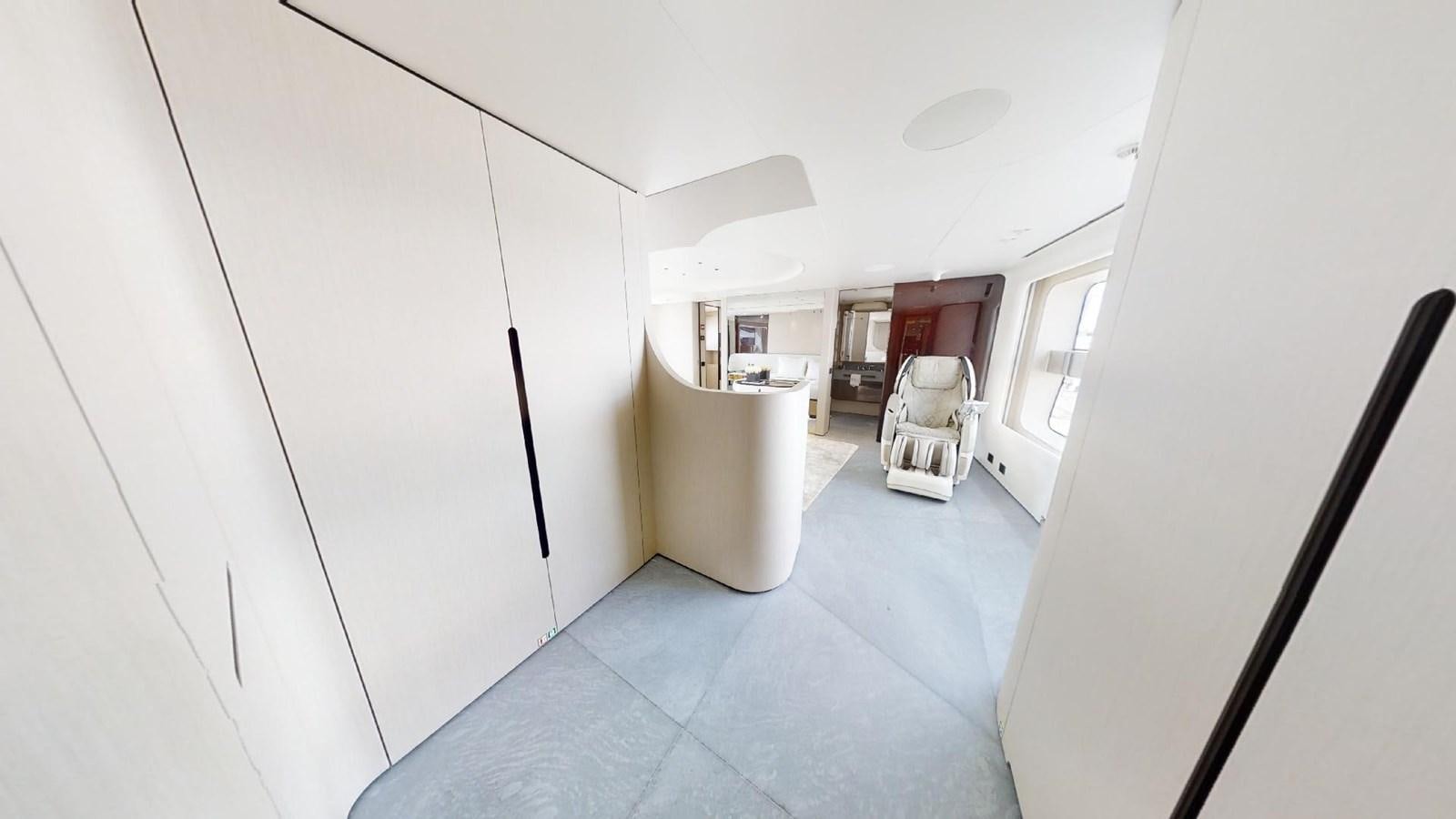 a hallway with a door and a chair aboard VOLO MARE Yacht for Sale