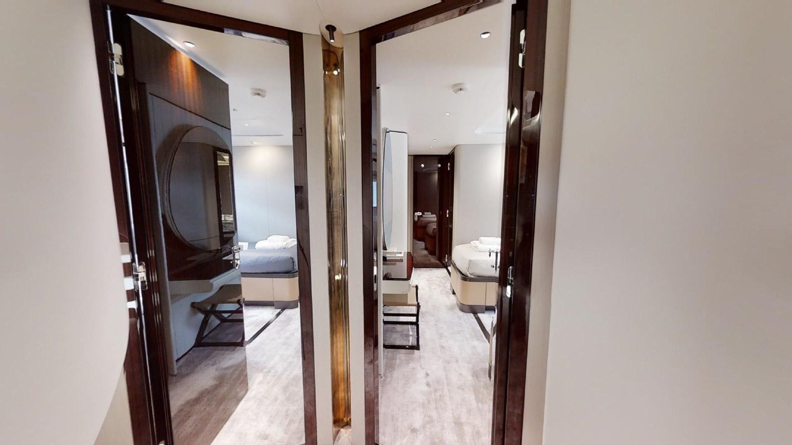 a hallway with a mirror and a bed aboard VOLO MARE Yacht for Sale