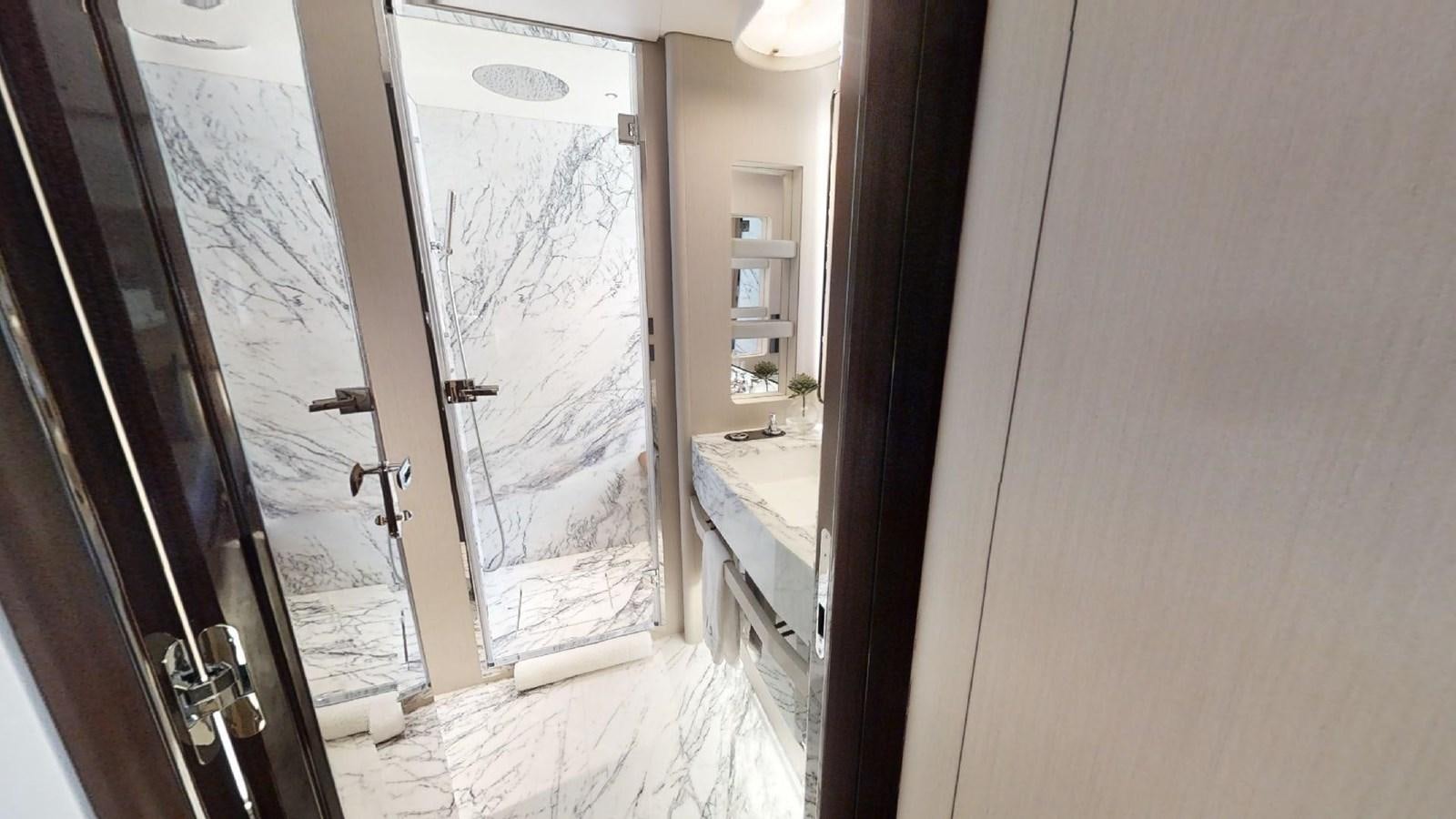 a room with a glass door and a window with a sink and a mirror aboard VOLO MARE Yacht for Sale