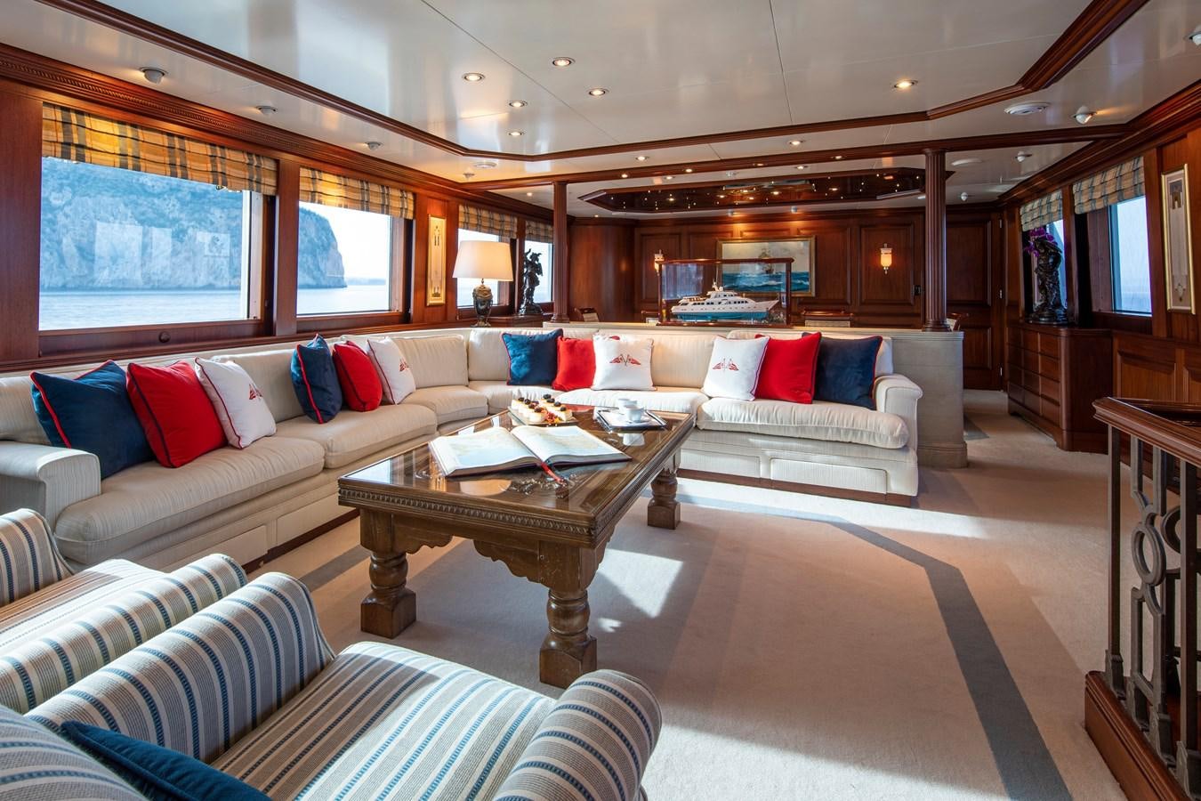 a living room with a couch and a coffee table aboard MONACO Yacht for Charter