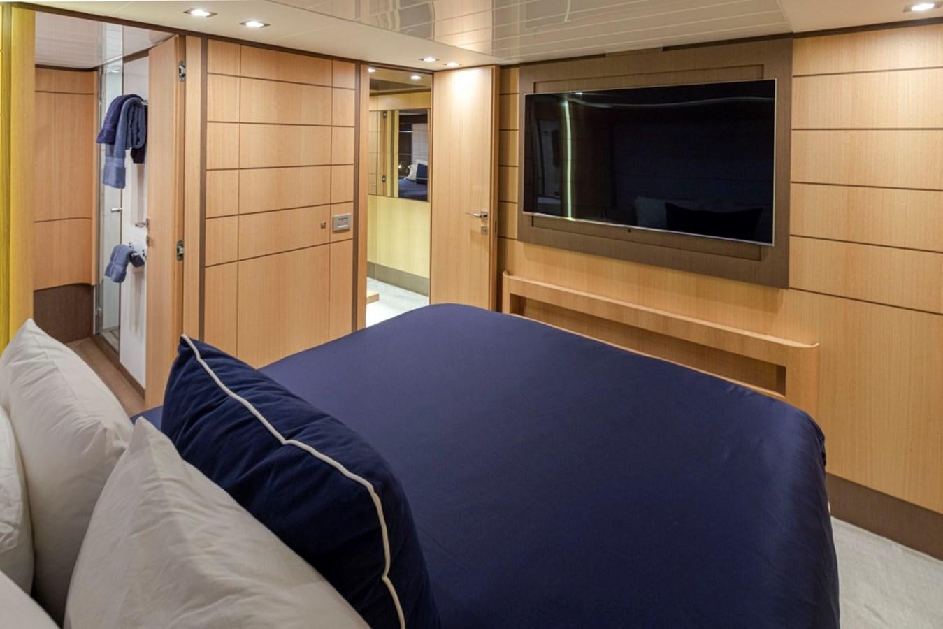 a bed with a blue sheet aboard SOL SHINE Yacht for Sale