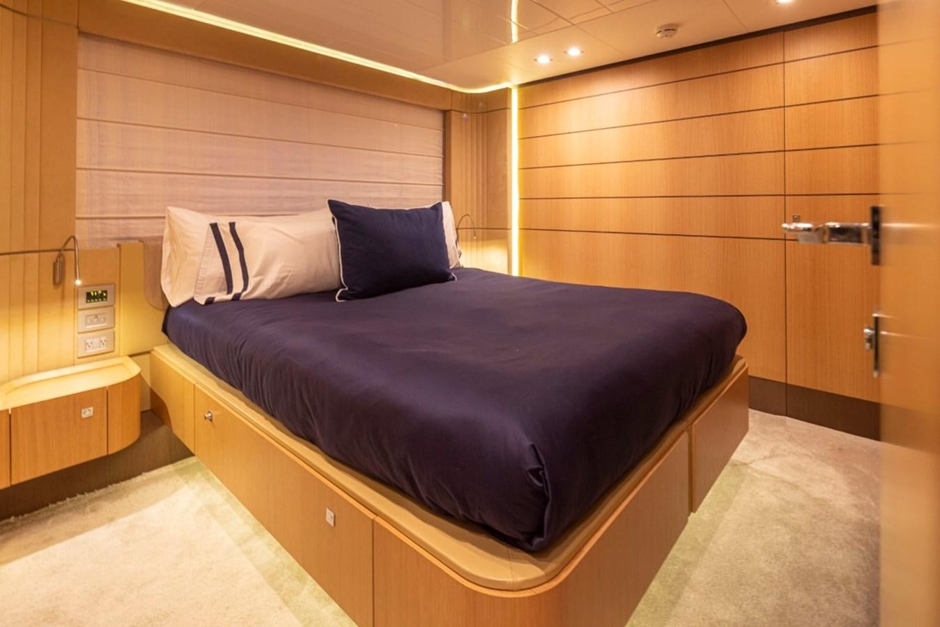 a bed with a blue pillow aboard SOL SHINE Yacht for Sale